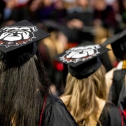 UGA graduates with decorated mortarboards