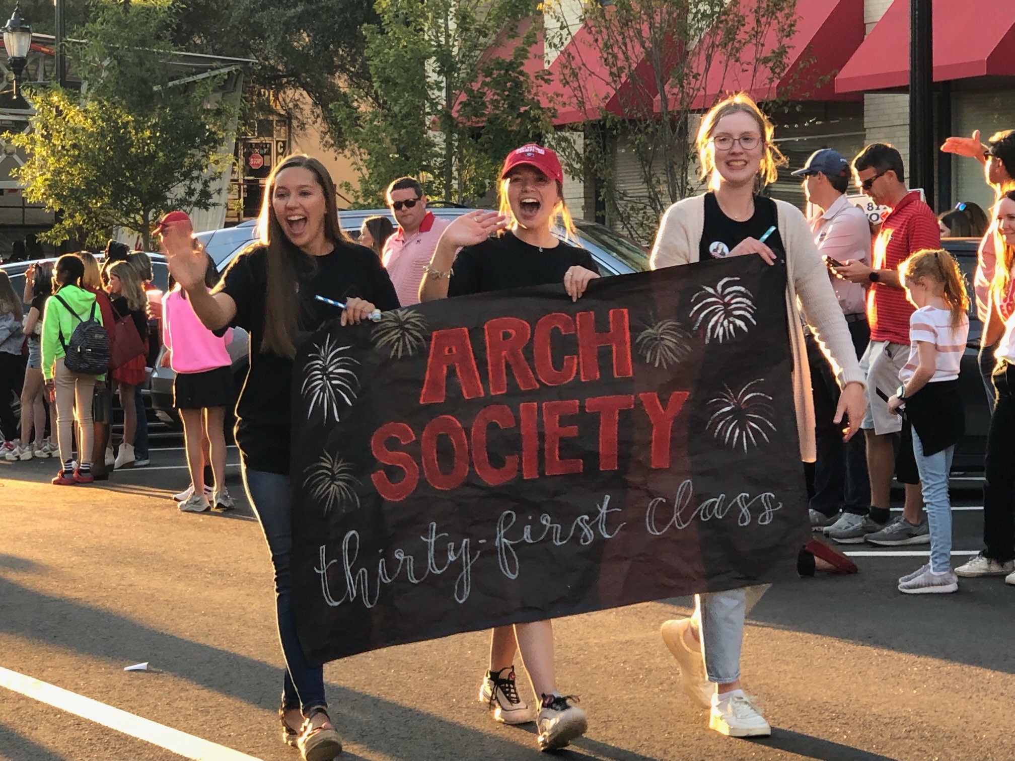 Arch Society students walk in the centennial homecoming parade