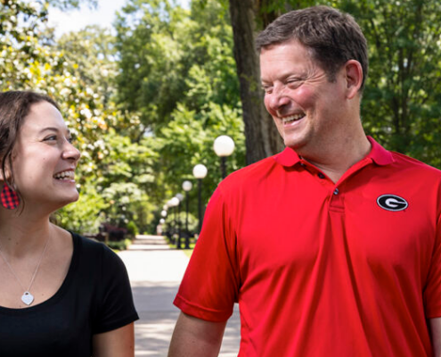 Blake Witmer, current Orientation leader, and father Craig Witmer, former Orientation leader, stroll together on North Campus. (PHOTO: Chamberlain Smith/UGA)