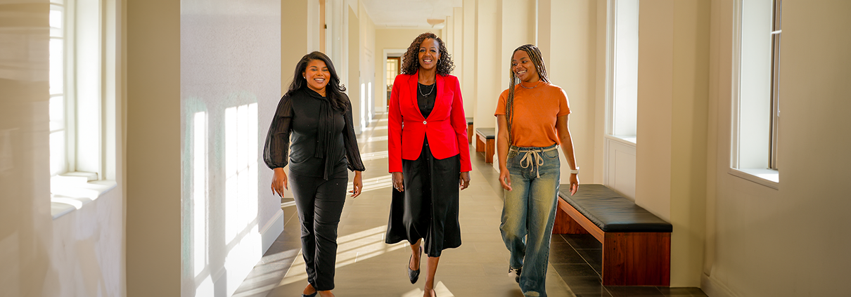 Mentor walks with mentees at the University of Georgia Terry College of Business.