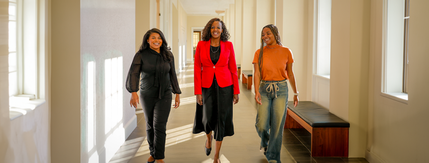 Mentor walks with mentees at the University of Georgia Terry College of Business.