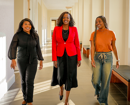 Mentor walks with mentees at the University of Georgia Terry College of Business.