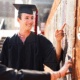 Students find their names on the Senior Signature plaque on campus.
