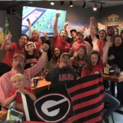 Game-watching party attendees pose for a photo in Jackson Hole, Wyoming.