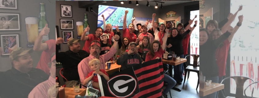 Game-watching party attendees pose for a photo in Jackson Hole, Wyoming.