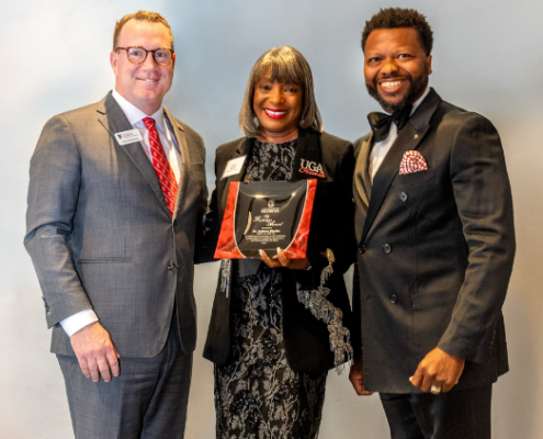 Jeremy Ransom, associate vice president for UGA development and alumni relations (left), and Corey Dortch, president of the UGA Alumni Association (right), presented the 2026 Footsteps Award to DeRetta Rhodes (center) at the annual 1961 Club Celebration in Atlanta in June. Photo credit: Cliff Robinson Photography.