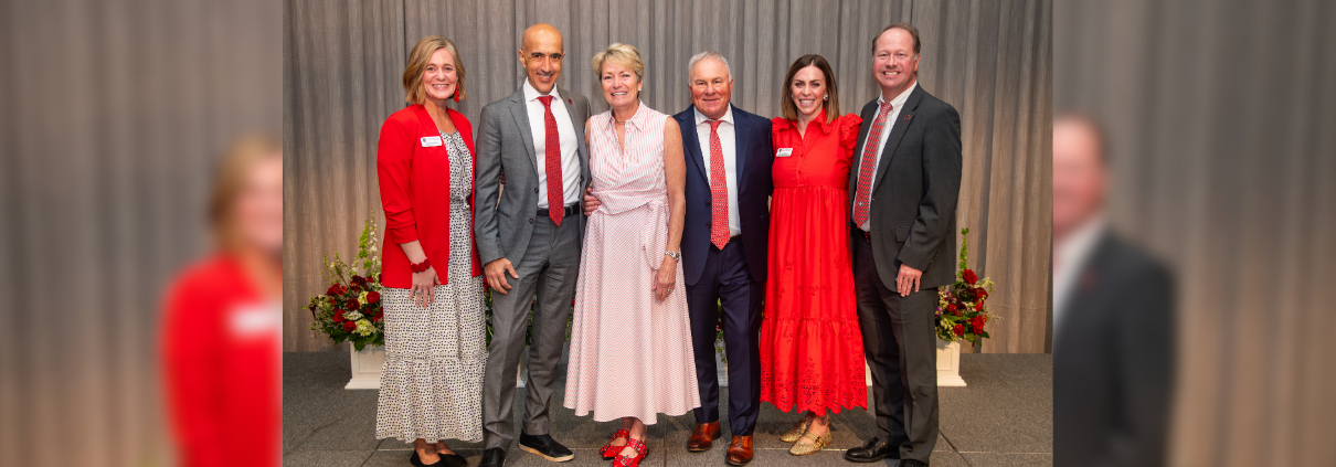 A group of people pictured on a stage in front of a gray backdrop at the 2026 UGA Alumni Awards Luncheon.