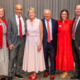 A group of people pictured on a stage in front of a gray backdrop at the 2026 UGA Alumni Awards Luncheon.
