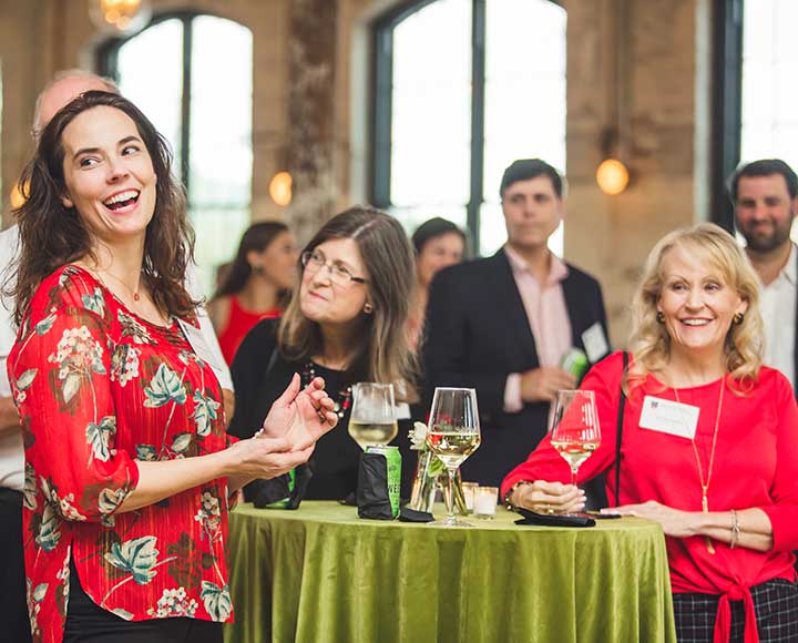 Reception attendee laughs during remarks.