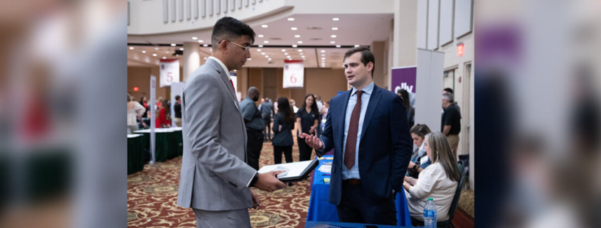 A UGA student discusses career options with a business representative at the 2021 UGA Career Fair at The Classic Center.