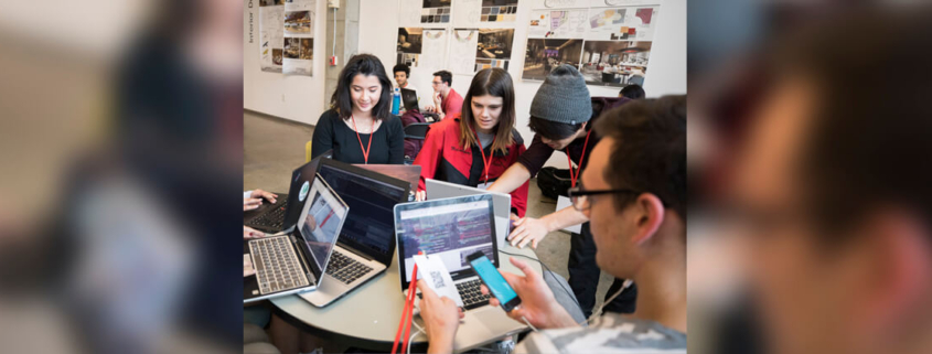 A UGA student group works on computers and phones.