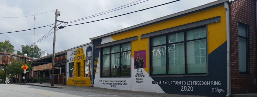 an image of a yellow and white mural featuring John Lewis