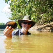 Frank Henning (PhD ’10) in holding up a river mussel.