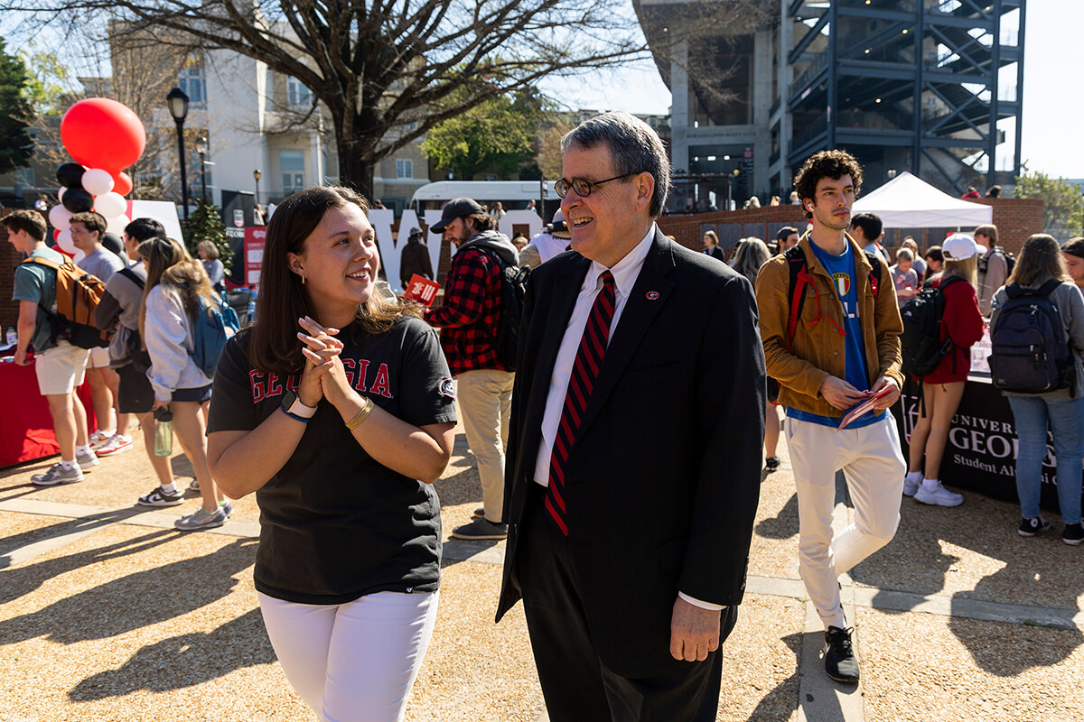President Jere W. Morehead talks with a student at the 2023 Dawg Day of Giving event at Tate Plaza. (Photo by Chamberlain Smith/UGA)