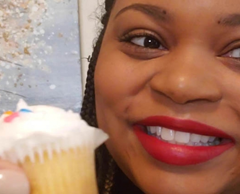 UGA mentor Ansley Booker raises a cupcake in a birthday salute to the UGA Mentor Program
