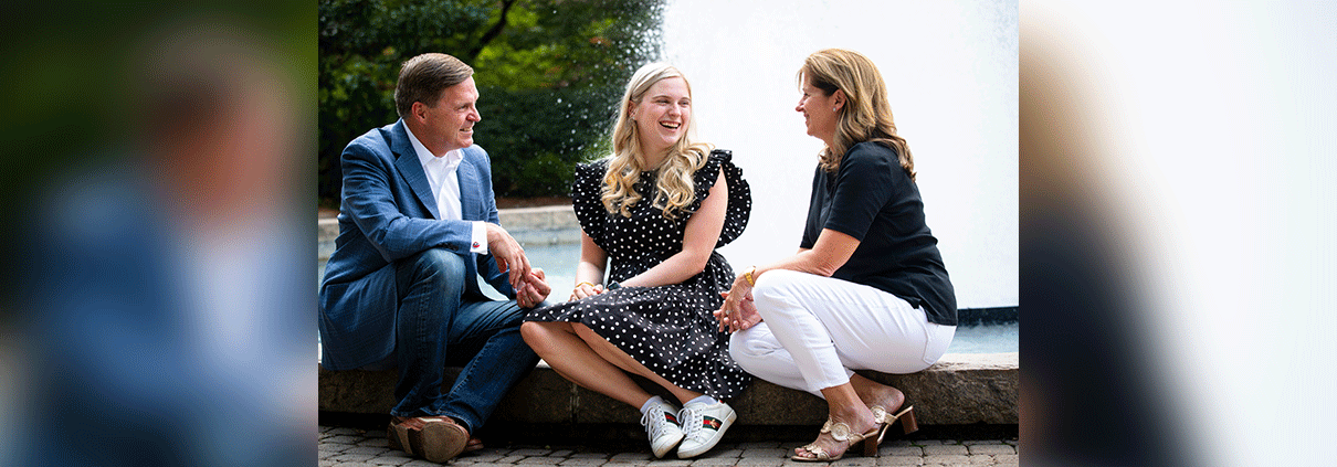 photo of Elizabeth Grace Mitchell and her parents, Jeff and Allison, by the Herty Field fountain