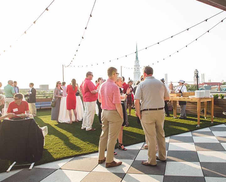 UGA alumni and friends converse on Perry Lane Hotel's rooftop.