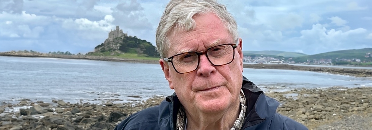 Bob Miller (AB ’64) poses in front of a castle while hiking in Penzance, England.