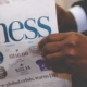 Hands holding business newspaper