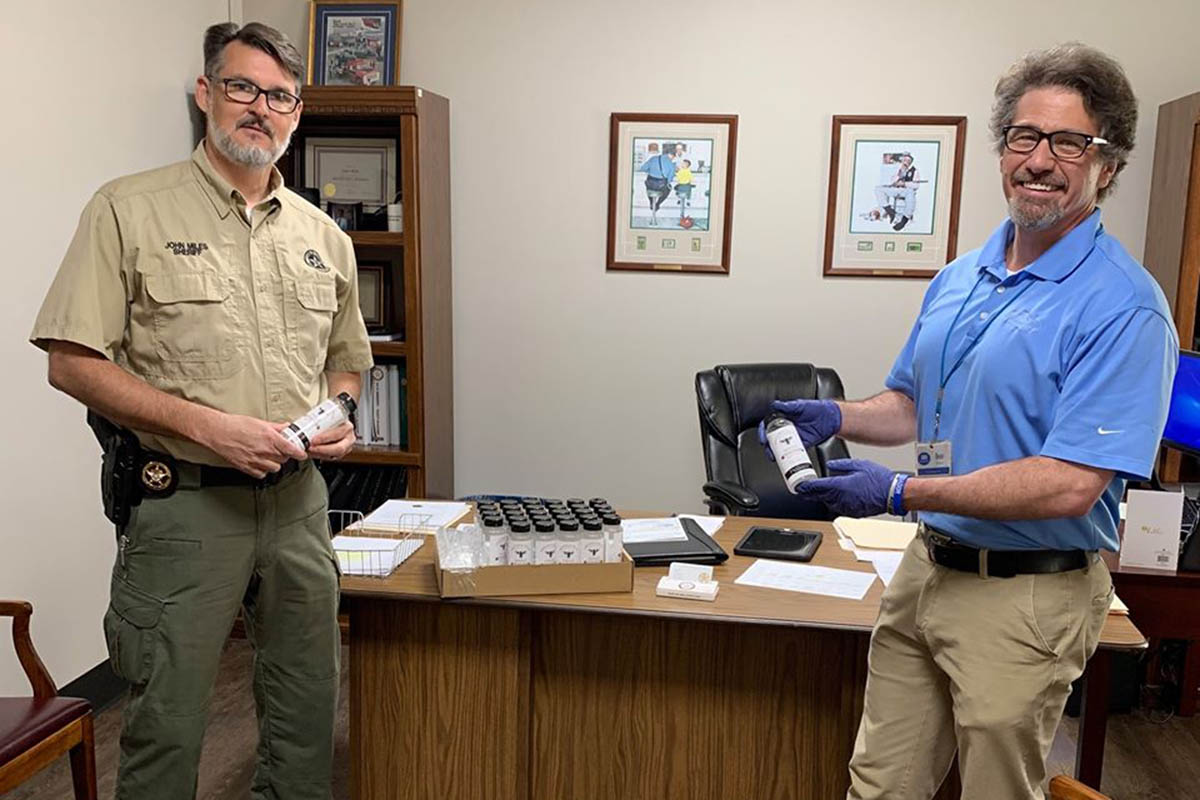 Dean Stone of IHS Pharmacy & Gifts delivers hand sanitizer to Candler County Sheriff John Miles & his team.” (photo provided by Dean Stone)