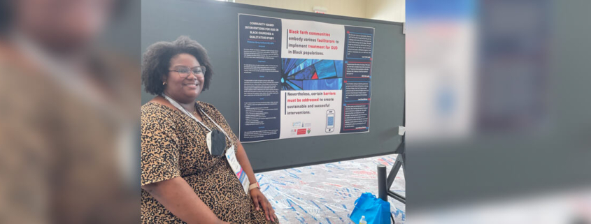 Ebony Caldwell poses next to her research poster.