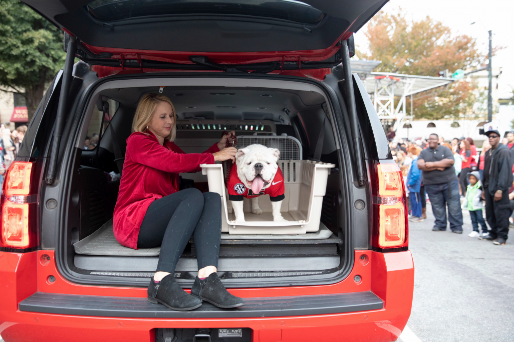 Uga in the trunk of Victory Red Suburban car 